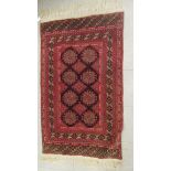 A Turkoman rug, decorated with repeating diamond formation and tasseled ends, on a red ground  51" x