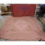 Two modern machine made throws, one on a red ground  140" x 70", the other pink  80" x 80"