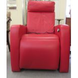 A modern Art Deco inspired, electrically powered stitched red upholstered, enclosed cinema