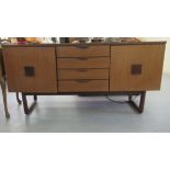 A Europe Furniture teak finished sideboard with a central bank of four drawers, flanked by a pair of