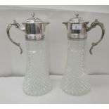 A pair of diamond pattern moulded glass wine jugs of tapered form with applied electroplated