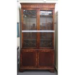 A modern reproduction of a Georgian crossbanded yewwood cabinet bookcase, the upper section with a