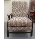 An early 20thC stained beech framed open arm chair, the floral patterned fabric cushioned back and