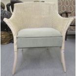 A Lloyd Loom white painted basketweave conservatory chair, raised on splayed legs