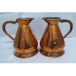 A pair of early 20thC copper, one gallon jugs, each bearing an indistinct London makers stamp