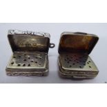 A 19thC scroll engraved silver vinaigrette with a hinged lid and folding grille; and another with