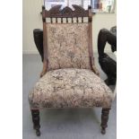 A late Victorian/Edwardian mahogany showwood framed salon chair, the pictorial fabric inspired,