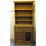 A early 20thC rustic pine kitchen dresser, the superstructure with three open shelves, over two