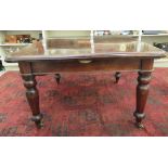 A late Victorian mahogany dining table, the two part top with round corners, raised on turned legs