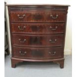 A modern mahogany finished bow front dressing chest with a brushing slide and four graduated long