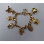 A 9ct gold curb link bracelet with seven 9ct gold and yellow metal charms