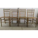 A set of four early 20thC gilded wooden bamboo effect, spindle back chairs, the plywood seats raised