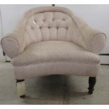 An early 20thC fabric upholstered salon/tub chair, raised on ring turned forelegs