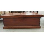 A modern fruitwood toy chest with a hinged lid and opposing brass handles  14"h  38"w