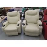 A pair of modern cream coloured faux hide upholstered. electrically adjustable, reclining chairs