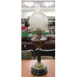 A late Victorian copper and brass oil lamp  20"h with a spherical glass shade and funnel