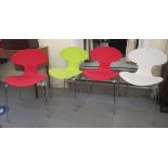 A set of four modern Comta moulded, coloured plastic and tubular steel framed kitchen chairs