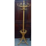 A modern beech bentwood style six branch coat/stick stand, raised on splayed legs  73"h