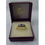 An 18ct gold sapphire and white stone ring