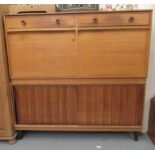 A Gordon Russell two part, teak finished living room unit, comprising two inline drawers with knob