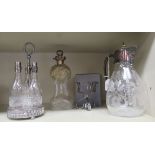 A mixed lot: to include a late Victorian glass and silver plated claret jug, engraved with swags