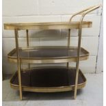 A late 20thC brass framed, three tier tea trolley with rosewood effect trays  26"h  27"w