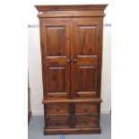 A modern stained pine wardrobe with two panelled doors and four base drawers, on a plinth  70"h