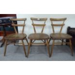 A children's' set of three mid 20thC Ercol beech and elm framed, double bar back stacking chairs,