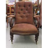 A William IV mahogany showwood framed salon chair, part button upholstered in brown fabric, raised