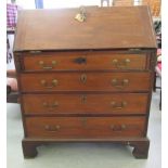 A George III mahogany bureau with a fall flap and four drawers, raised on bracket feet  42"h  36"w