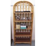 A modern bamboo framed display stand with five fixed shelves  69"h  28"w