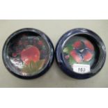 Two Moorcroft pottery pin dishes, one decorated in the Pomegranate design  bears variously impressed