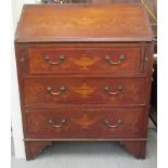 An Edwardian satinwood inlaid mahogany bureau with a fall flap and three drawers, raised on