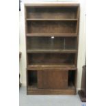 An early 20thC oak four section stacking bookcase, on a plinth  59"h  34"w