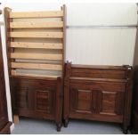 A pair of modern stained pine single bed frames, each with a panelled head and foot  38"w