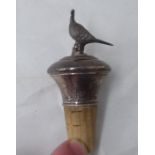 A silver mounted wine bottle cork, surmounted by a pheasant  marks rubbed