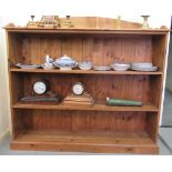 A modern stained pine three tier open front bookcase, on a plinth  53"h  58"w