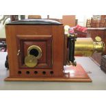 An early 20thC Negretti & Zambra of London brass and mahogany cased magic lantern  12"h with a