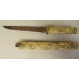 A 19thC Japanese rustically carved bone handled short sword/dagger with a matching scabbard  the
