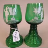 A pair of early 20thC Continental tinted green wine glasses with cup shape bowls, on tapered,