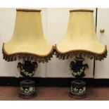 A pair of early 20thC majolica table lamps of pedestal vase design, decorated in colours with