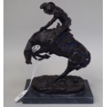 A cast and patinated bronze model, a mounted rodeo rider, on a naturalistic base and slate plinth