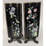 A pair of late 19thC tall, serpentine outlined black enamelled glass, square vases, overpainted with