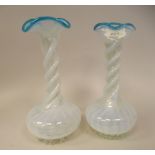 A pair of late 19thC tinted blue vaseline glass bottle vases of squat, bulbous form with long