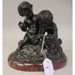 After Clodion - a cast and patinated bronze group, two cherubic figures, seated on a naturalistic