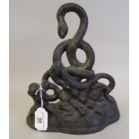 A 19thC painted cast iron door porter, fashioned as entwined serpents, on a naturalistic base  10"h