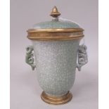 An early 20thC Chinese green coloured crackle glazed twin handled porcelain cup shape vase and cover