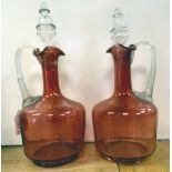 A pair of late 19thC cream and cranberry glass mallet shape wine decanters with long, narrow
