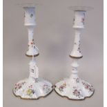 A pair of late 18thC South Staffordshire white enamel candlesticks, each having a detachable wavy