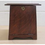 An Arts & Crafts oak desk top stationary/letter rack with a fall front and hinged lid, on bracket